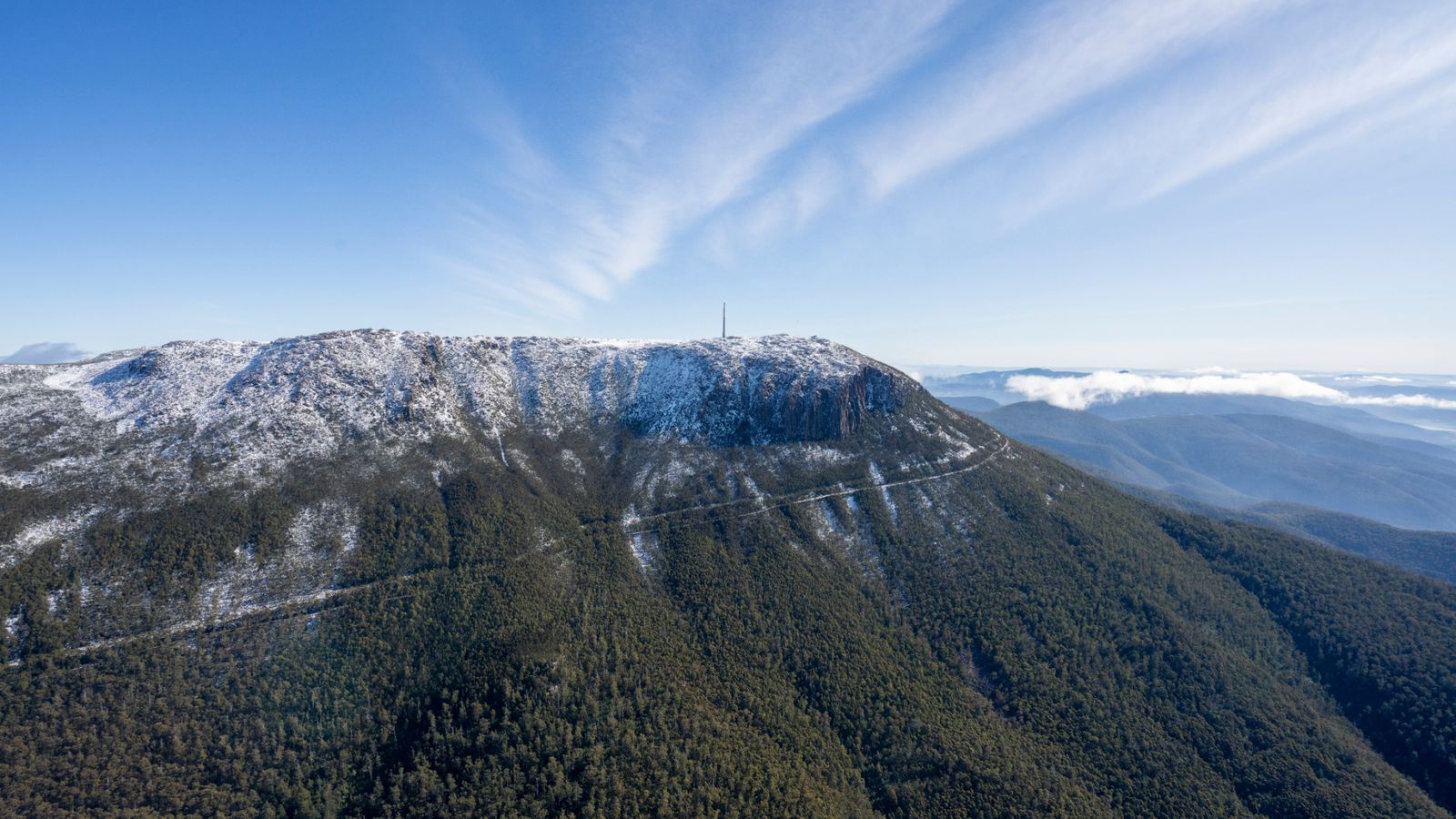 Aerial view of Wellington Park showing forested slopes, Pinnacle Road and the summit area.